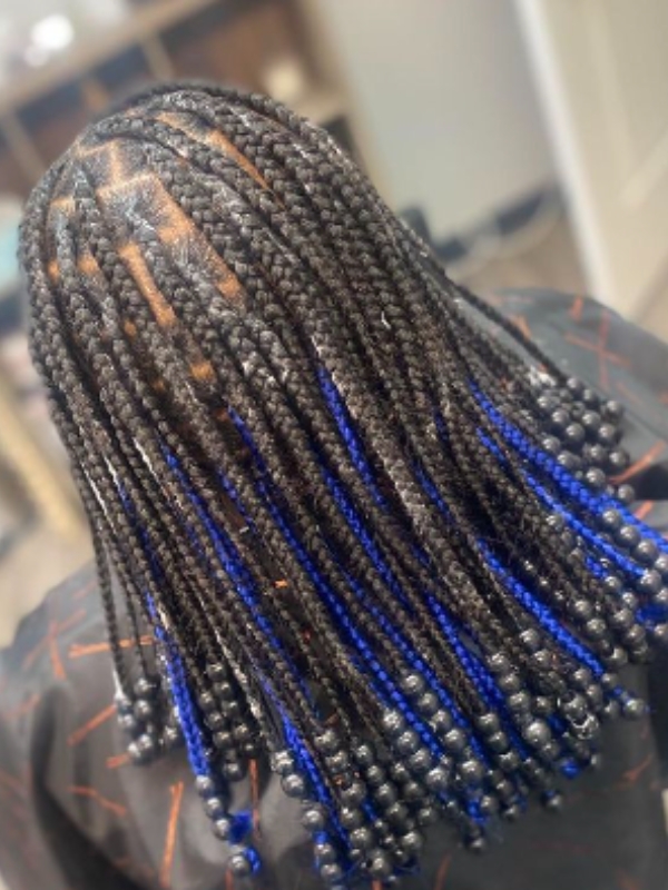 Electric blue peekaboo braids are a daring choice for those who love to stand out.