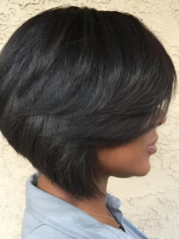 A short inverted bob haircut with a side part is perfect for thick, straight hair. 