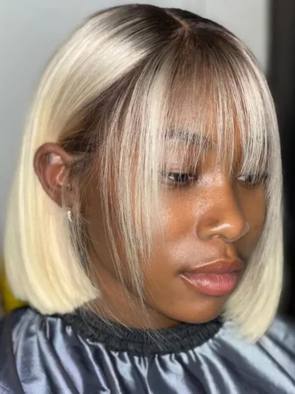 A blonde bob haircut with straight hair and wispy bangs is a striking and stylish choice. 